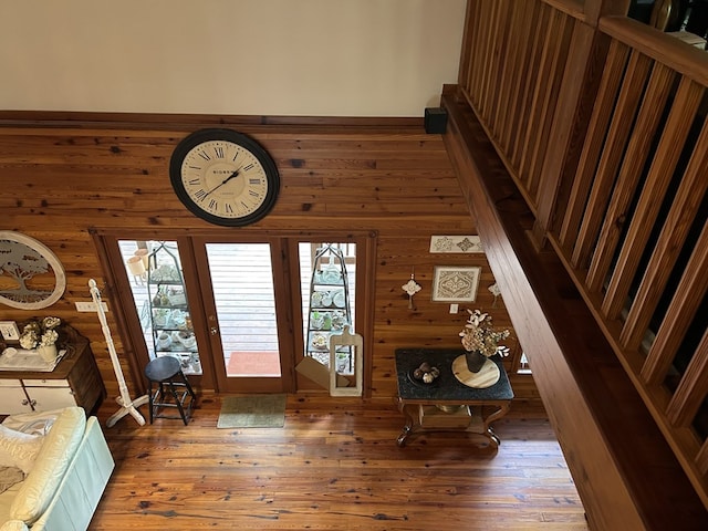 foyer entrance with wood walls and hardwood / wood-style flooring
