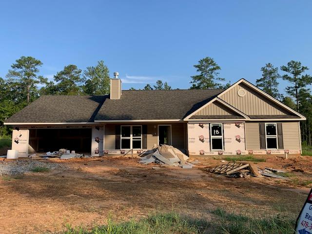 view of front of home with an attached garage and a chimney