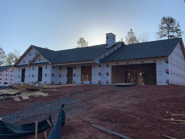 unfinished property with central AC and a garage