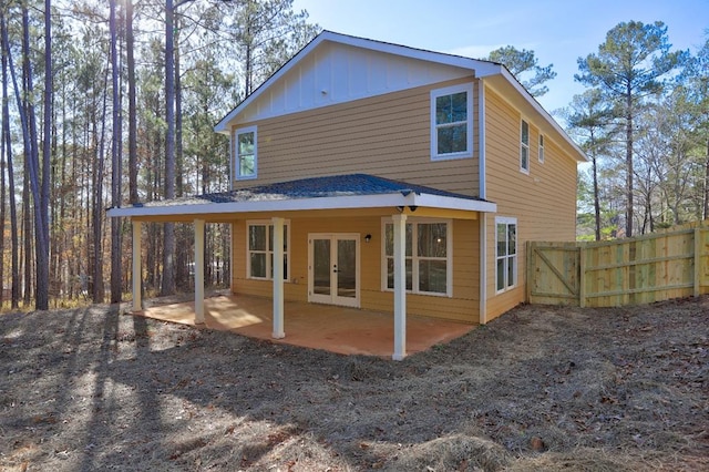 back of property with fence, french doors, and a patio