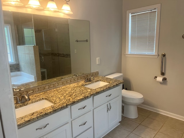 bathroom with tile patterned floors, vanity, toilet, and a shower with shower door