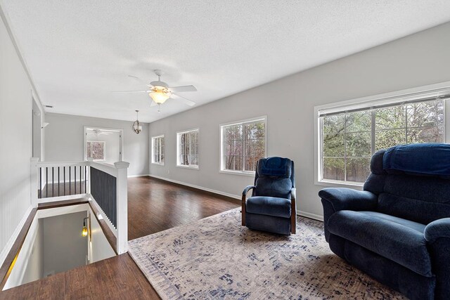 unfurnished living room with a textured ceiling and a brick fireplace