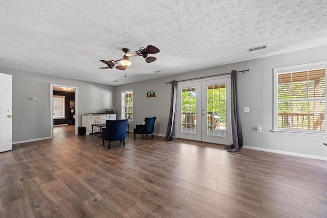 111 Southlake Dr, Eatonton, GA 31024 - living area with french doors, a textured ceiling, visible vents, wood finished floors, and ceiling fan