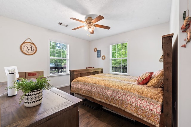 111 Southlake Dr, Eatonton, GA 31024 - bedroom featuring dark wood finished floors, baseboards, ceiling fan, and visible vents
