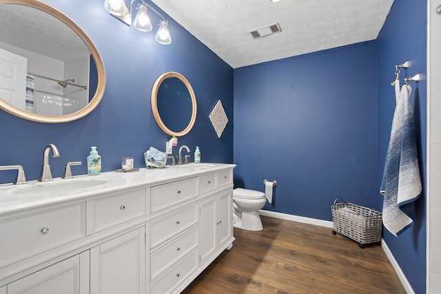 111 Southlake Dr, Eatonton, GA 31024 - bathroom featuring wood finished floors, toilet, baseboards, and a sink