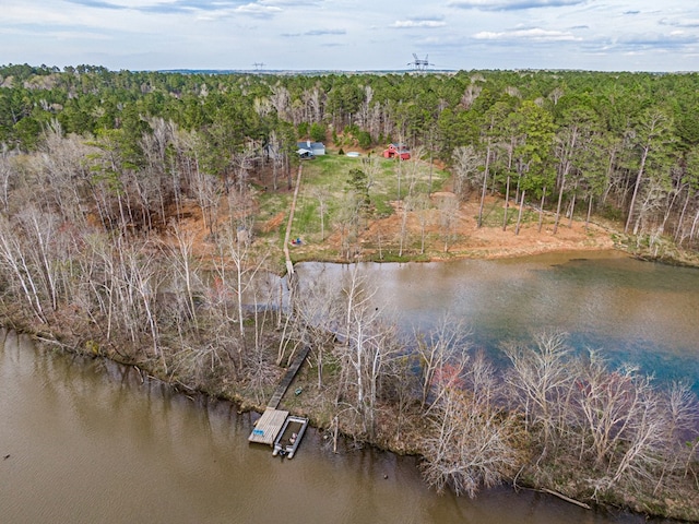 aerial view featuring a forest view and a water view