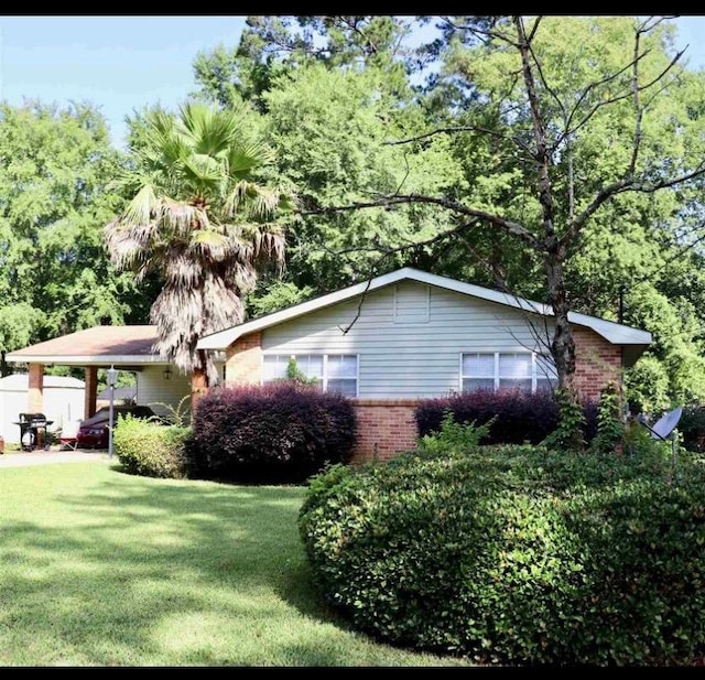 view of property exterior with a lawn and a carport