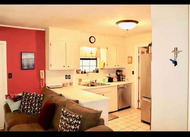 kitchen featuring white cabinetry, sink, light tile patterned floors, and appliances with stainless steel finishes