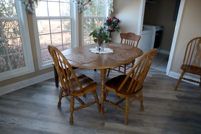 dining space with dark hardwood / wood-style floors and washer and clothes dryer