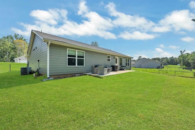 back of property with a patio area, a yard, central AC unit, and an outdoor hangout area