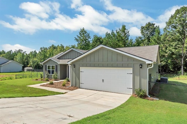 view of front facade with a garage, central air condition unit, and a front lawn