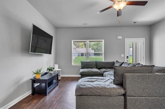 living room with dark hardwood / wood-style floors and ceiling fan