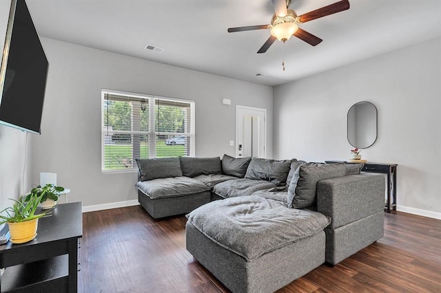 living room with ceiling fan and dark wood-type flooring