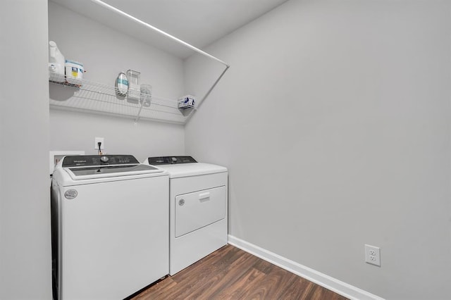 washroom with washer and dryer and dark hardwood / wood-style flooring