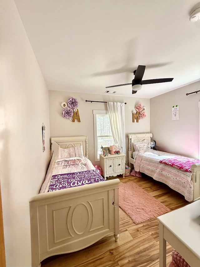 bedroom with light wood-type flooring and ceiling fan