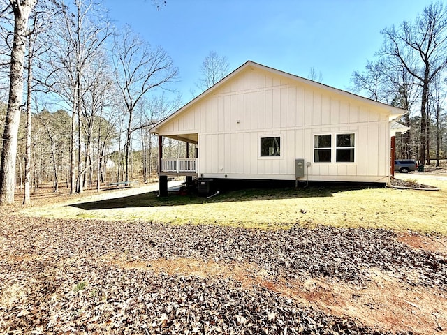 view of property exterior featuring central air condition unit and a lawn