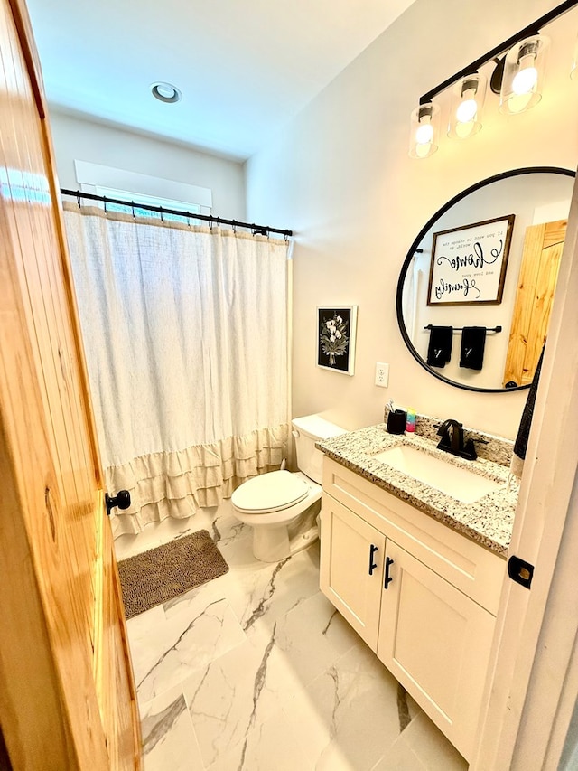 full bathroom featuring toilet, marble finish floor, shower / bath combo with shower curtain, and vanity