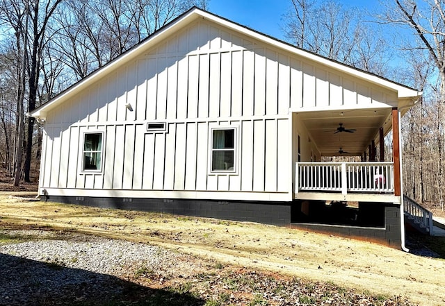 view of property exterior featuring board and batten siding, a porch, and a ceiling fan