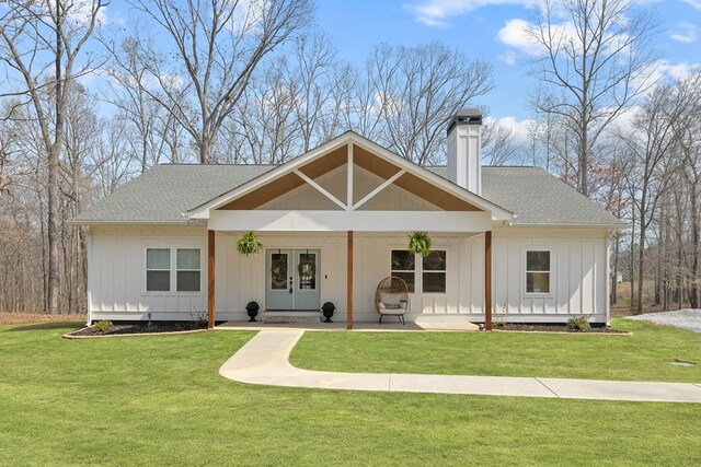 back of house featuring board and batten siding, stairway, and a ceiling fan