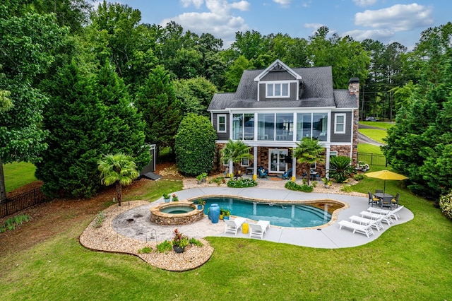 202 Jackson Rd, Milledgeville, GA 31061 - back of house featuring stone siding, a patio area, a balcony, a chimney, and a pool with connected hot tub