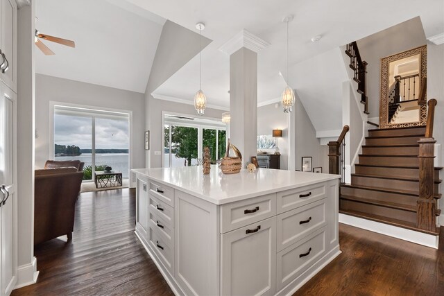 202 Jackson Rd, Milledgeville, GA 31061 - kitchen with vaulted ceiling, dark wood-type flooring, white cabinetry, pendant lighting, and light countertops