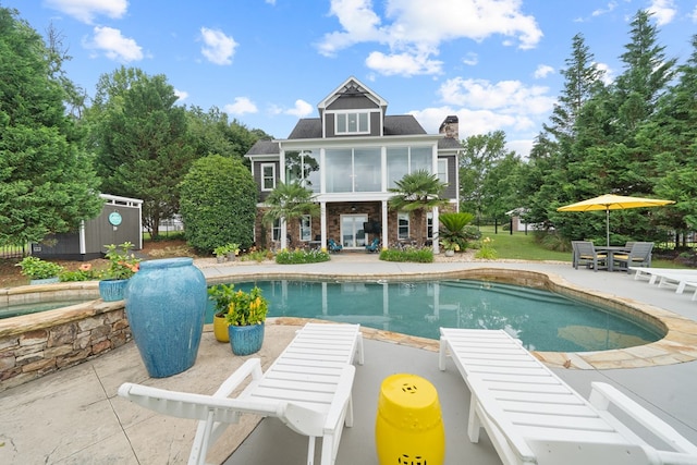 202 Jackson Rd, Milledgeville, GA 31061 - view of swimming pool featuring a patio area, outdoor dining area, an outdoor structure, and a sunroom