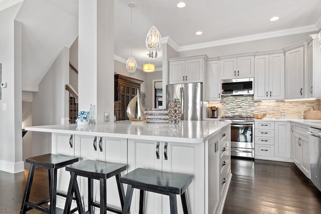 202 Jackson Rd, Milledgeville, GA 31061 - kitchen with stainless steel appliances, crown molding, a breakfast bar, backsplash, and light countertops