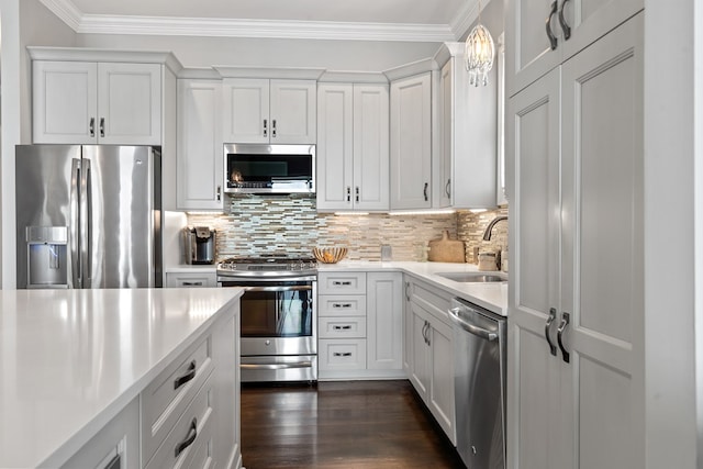 202 Jackson Rd, Milledgeville, GA 31061 - kitchen featuring stainless steel appliances, light countertops, ornamental molding, backsplash, and white cabinets