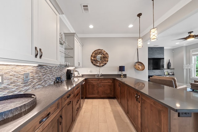 202 Jackson Rd, Milledgeville, GA 31061 - kitchen featuring dark countertops, tasteful backsplash, light wood finished floors, recessed lighting, and a peninsula