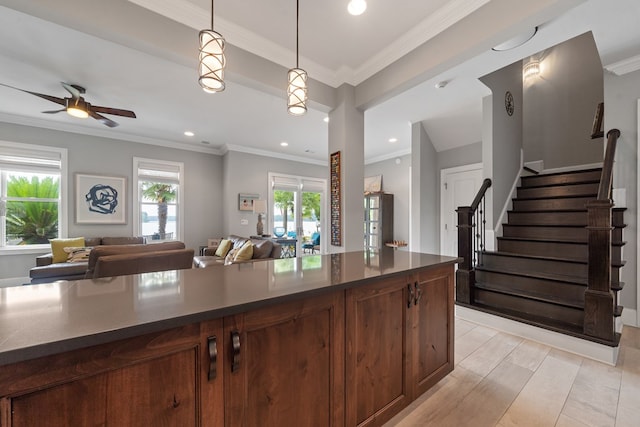 202 Jackson Rd, Milledgeville, GA 31061 - kitchen featuring dark countertops, open floor plan, pendant lighting, a ceiling fan, and crown molding
