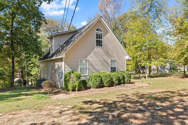 view of property exterior featuring cooling unit and a yard