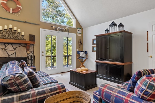 carpeted living room with a fireplace, a textured ceiling, and high vaulted ceiling