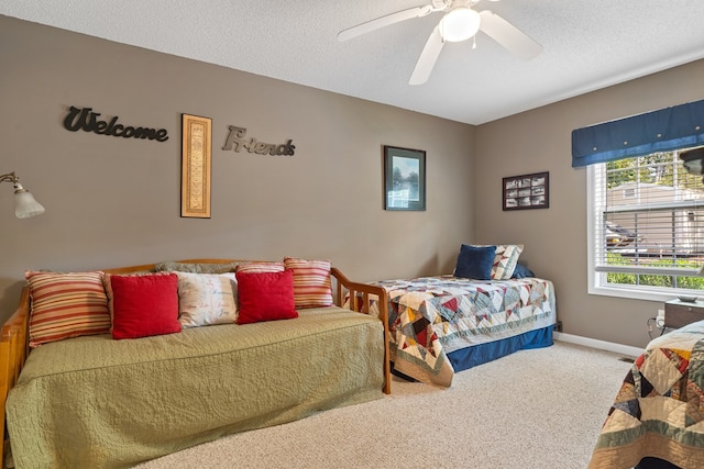 bedroom featuring ceiling fan, carpet floors, and a textured ceiling