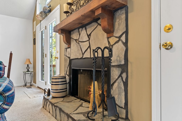 interior details featuring a fireplace and carpet floors