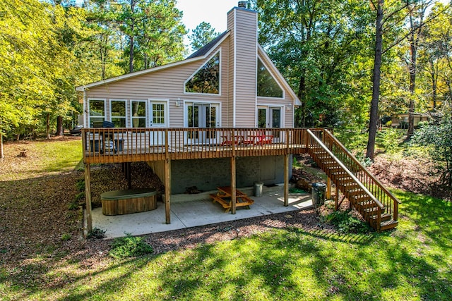 rear view of house featuring a yard, a patio, and a wooden deck