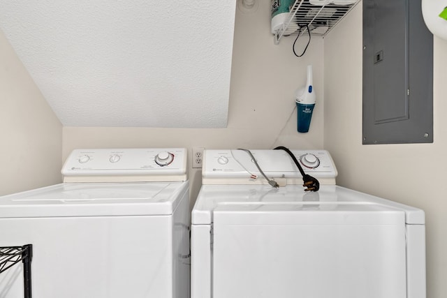 clothes washing area with washer and dryer and electric panel