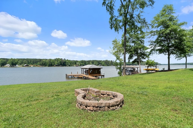dock area with a lawn, a water view, and boat lift
