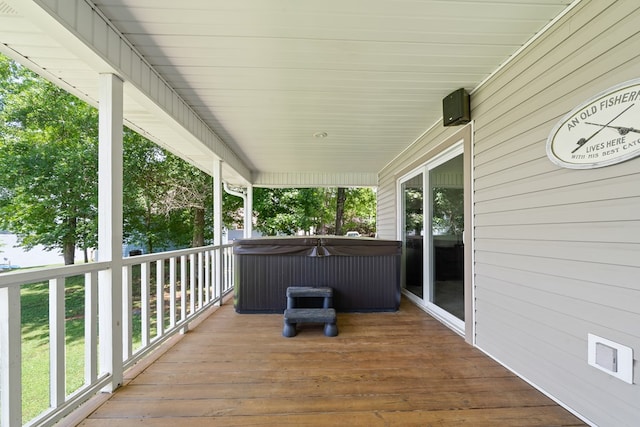 wooden deck featuring a hot tub