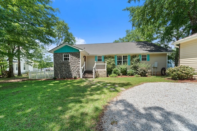 ranch-style home with stone siding and a front lawn