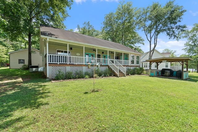 view of front facade with a ceiling fan, a front yard, a porch, and central AC