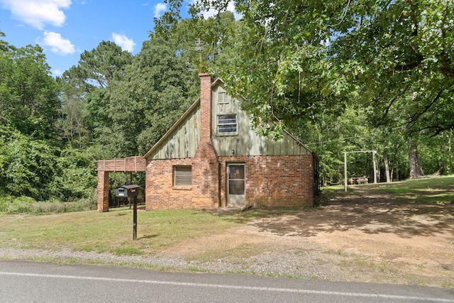 2163 N Jefferson St, Milledgeville, GA 31061 - view of side of home featuring a lawn, a chimney, and brick siding