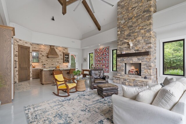 2163 N Jefferson St, Milledgeville, GA 31061 - living room with high vaulted ceiling, a fireplace, beamed ceiling, a ceiling fan, and concrete floors