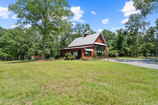 2163 N Jefferson St, Milledgeville, GA 31061 - view of front of home featuring a front lawn, a metal roof, and driveway