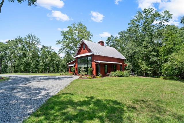 2163 N Jefferson St, Milledgeville, GA 31061 - view of side of property featuring a yard, a chimney, a metal roof, and gravel driveway