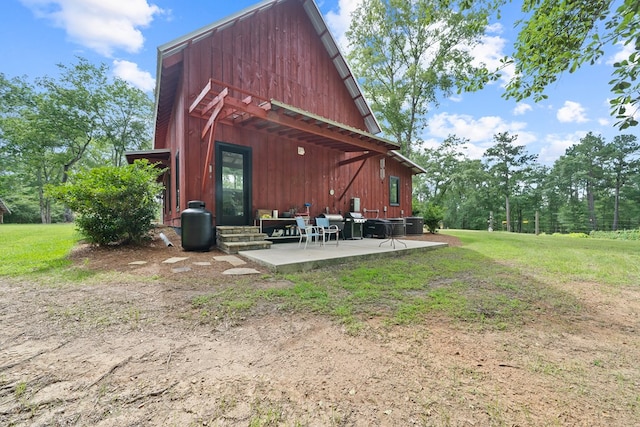 2163 N Jefferson St, Milledgeville, GA 31061 - rear view of property with a patio and a lawn