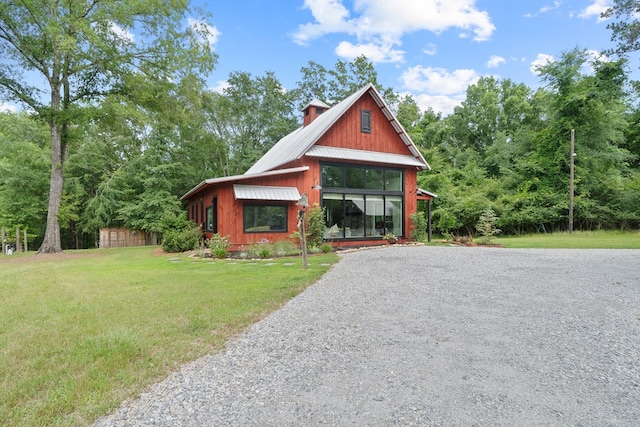 2163 N Jefferson St, Milledgeville, GA 31061 - view of front of home featuring a front yard, a metal roof, and driveway