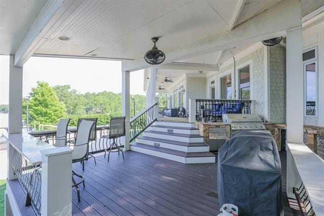 wooden terrace featuring area for grilling and a ceiling fan