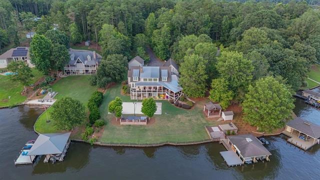 drone / aerial view with a water view and a wooded view