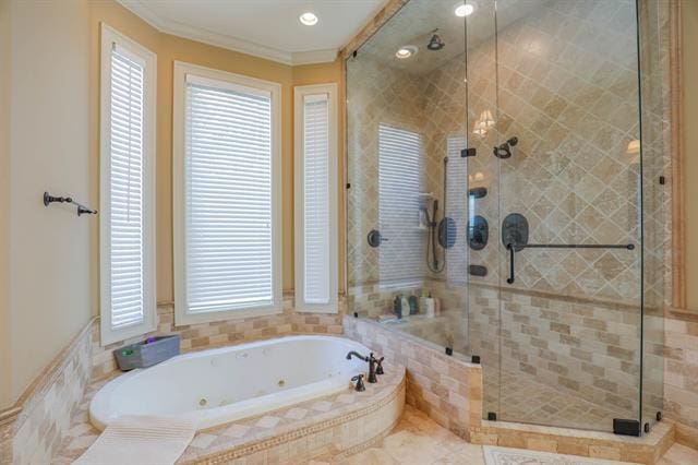 bathroom featuring crown molding, a jetted tub, and a shower stall