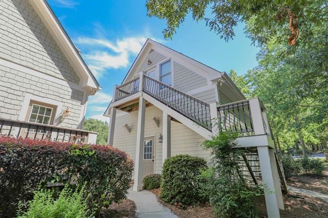 view of side of property featuring stairs